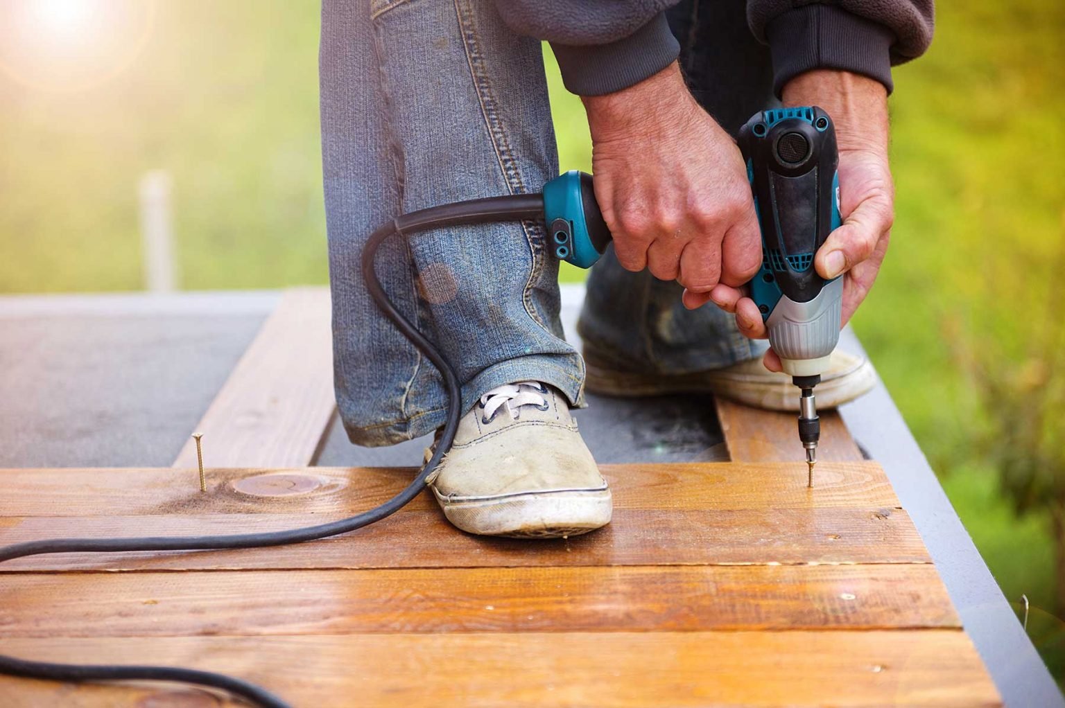 Craftsmen installing wooden flooring in a residential space