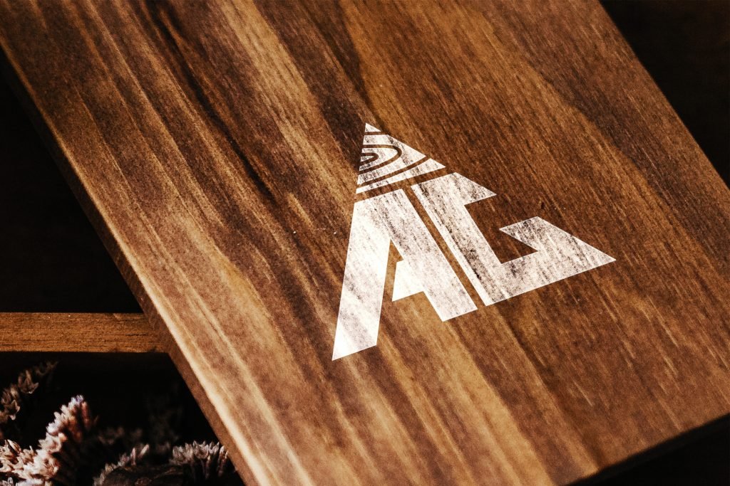 AG Floor Covering logo on a polished walnut board