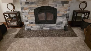 Living room with a stacked-stone fireplace