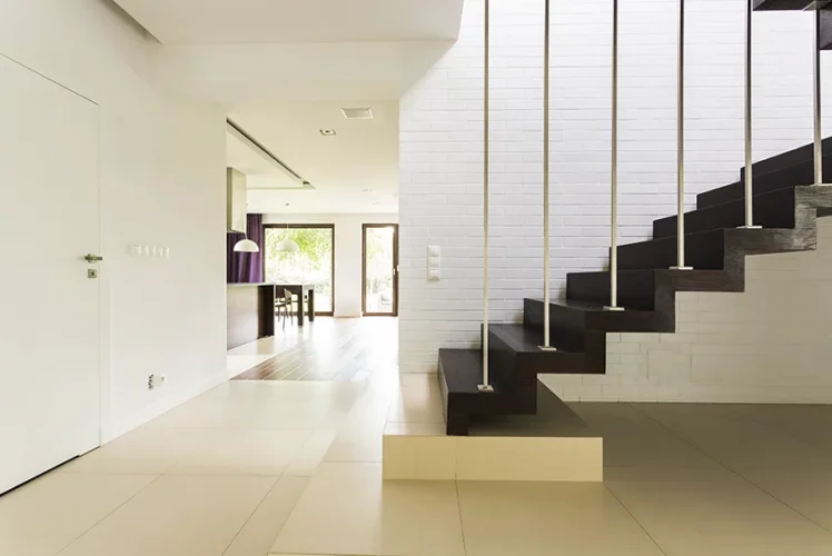 Wooden staircase set against an exposed brick wall